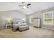 Spacious main bedroom with vaulted ceiling, two windows, neutral carpet, ceiling fan and furniture at 109 Lyngrove St, Holly Springs, NC 27540