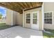 Covered outdoor patio area with a back door access, perfect for relaxation at 109 Lyngrove St, Holly Springs, NC 27540