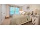 Bright bedroom featuring neutral walls, carpeted floor, a plush bed with decorative pillows, and natural light from the window at 1101 Compass Dr, Durham, NC 27713
