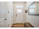 Bright entryway features wood flooring, a bench, and a mirror at 1101 Compass Dr, Durham, NC 27713