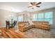 Bright living room features a large sectional sofa, wood flooring, and a dining table at 1101 Compass Dr, Durham, NC 27713