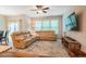 Bright living room features a large sectional sofa, wood flooring, and entertainment center at 1101 Compass Dr, Durham, NC 27713