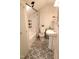 Bathroom featuring tub shower combo, pedestal sink, and patterned tile floor at 1111 College St, Oxford, NC 27565