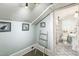 Bathroom with blue walls, patterned tile floor, shower, ladder and framed pictures at 1111 College St, Oxford, NC 27565