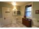 Spacious bathroom featuring a tiled floor, natural light from the window, and a chandelier at 1111 College St, Oxford, NC 27565