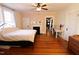 Spacious bedroom with wood floors, fireplace, and natural light from the windows at 1111 College St, Oxford, NC 27565