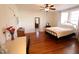 Bright bedroom with wood floors, a ceiling fan, and natural light from the large windows at 1111 College St, Oxford, NC 27565