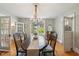 Elegant dining room with chandelier, a large table, and natural light from surrounding windows at 1111 College St, Oxford, NC 27565