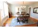 A formal dining room with wood floors, an elegant chandelier, and a decorative rug at 1111 College St, Oxford, NC 27565