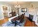 Charming dining room with fireplace, wood floors, chandelier, and room for entertaining at 1111 College St, Oxford, NC 27565