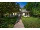 Inviting home with a covered front porch, black shutters, dormer windows, and manicured lawn at 1111 College St, Oxford, NC 27565