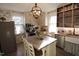 This kitchen features stainless steel appliances, a kitchen island, and wallpaper at 1111 College St, Oxford, NC 27565