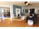 Cozy living room with a fireplace, hardwood floors, and open access to the dining area at 1111 College St, Oxford, NC 27565