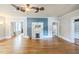 Open living room with hardwood floors, a fireplace, and access to other rooms at 1111 College St, Oxford, NC 27565