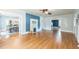 Bright living room featuring hardwood floors, a fireplace, and doorways to other rooms at 1111 College St, Oxford, NC 27565