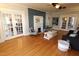 Well-lit living room with hardwood floors, a fireplace, and access to other rooms at 1111 College St, Oxford, NC 27565