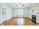A living room featuring a fireplace, hardwood floors, and multiple windows at 1111 College St, Oxford, NC 27565