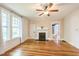 Living room boasts hardwood floors, fireplace, and natural light from large windows at 1111 College St, Oxford, NC 27565