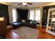 Relaxing living room featuring hardwood floors, comfortable seating, and large windows at 1111 College St, Oxford, NC 27565
