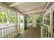 Enclosed screened porch with brick flooring, white trim, and natural light at 1111 College St, Oxford, NC 27565