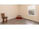 This bedroom has wood-look flooring and a single window at 116 Laurel Ave, Durham, NC 27701