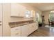 Bright kitchen with white cabinetry, sleek countertops, and a functional layout for cooking and entertaining at 116 Laurel Ave, Durham, NC 27701