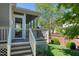 Backyard featuring a screened porch, stairs, a grill and landscaping for privacy at 121 Bridgegate Dr, Cary, NC 27519