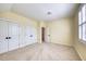 Bright bedroom with neutral carpet, two closets, and an en suite bathroom at 121 Bridgegate Dr, Cary, NC 27519