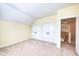 Well lit bedroom with wall-to-wall carpet and a doorway leading to a hallway at 121 Bridgegate Dr, Cary, NC 27519