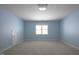 Bedroom with blue walls and carpeted floors, and a view of the window at 121 Bridgegate Dr, Cary, NC 27519