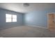 Bedroom with blue walls, carpeted floors, a closet and a window for natural light at 121 Bridgegate Dr, Cary, NC 27519