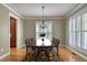 Elegant dining room featuring hardwood floors, a chandelier, and plantation shutters at 121 Bridgegate Dr, Cary, NC 27519