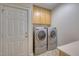 Convenient laundry room features washer, dryer, storage cabinets, and countertop at 121 Bridgegate Dr, Cary, NC 27519