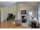 Bright living room with vaulted ceiling, fireplace, and elegant furnishings at 121 Bridgegate Dr, Cary, NC 27519
