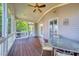 The screened porch features wood flooring and a ceiling fan, perfect for enjoying the outdoors at 121 Bridgegate Dr, Cary, NC 27519