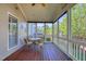 Inviting screened porch with wood floors offers a relaxing space for outdoor dining and relaxation at 121 Bridgegate Dr, Cary, NC 27519