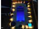 Nighttime aerial view of pool, patio, hot tub, and backyard with landscape lighting at 1302 Reading Ct, Burlington, NC 27217