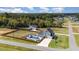 Aerial view of the property showcasing the house, fenced yard, and in-ground swimming pool with patio furniture at 1302 Reading Ct, Burlington, NC 27217