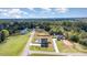 Expansive aerial view of the property featuring a pool, large yard, and surrounding wooded area, offering privacy at 1302 Reading Ct, Burlington, NC 27217