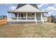 Charming backyard view showcasing a well-maintained lawn and a lovely back porch at 1302 Reading Ct, Burlington, NC 27217