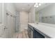 Clean bathroom with white wainscoting, shower and tub combo and vanity at 1302 Reading Ct, Burlington, NC 27217
