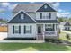 Attractive two-story home featuring a covered porch, well-maintained lawn, and professional landscaping at 1302 Reading Ct, Burlington, NC 27217