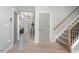 Inviting foyer with hardwood floors, a staircase with wooden railing, and a view into the living spaces at 1302 Reading Ct, Burlington, NC 27217