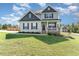 Charming two-story home with a welcoming front porch and well-manicured lawn and stylish landscaping at 1302 Reading Ct, Burlington, NC 27217