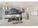 A view of the kitchen showing the countertops, stainless appliances, subway tile, and attractive pendant lights at 1302 Reading Ct, Burlington, NC 27217