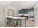 A full view of the kitchen showing an island with seating, appliances, countertops, and dining area at 1302 Reading Ct, Burlington, NC 27217
