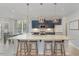 This spacious kitchen features an island with seating, modern appliances, and stylish lighting at 1302 Reading Ct, Burlington, NC 27217
