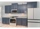 A view of the kitchen appliances, countertops, and subway tile backsplash at 1302 Reading Ct, Burlington, NC 27217