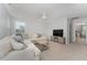 Open-concept living room with comfortable seating, ceiling fan and a modern fireplace at 1302 Reading Ct, Burlington, NC 27217