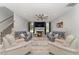 A well-lit living room features a fireplace with a large ceiling fan at 1302 Reading Ct, Burlington, NC 27217